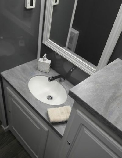 Port-A-Lisa 2-Station Restroom Trailer with a flushable sink, mirror, and cabinets.