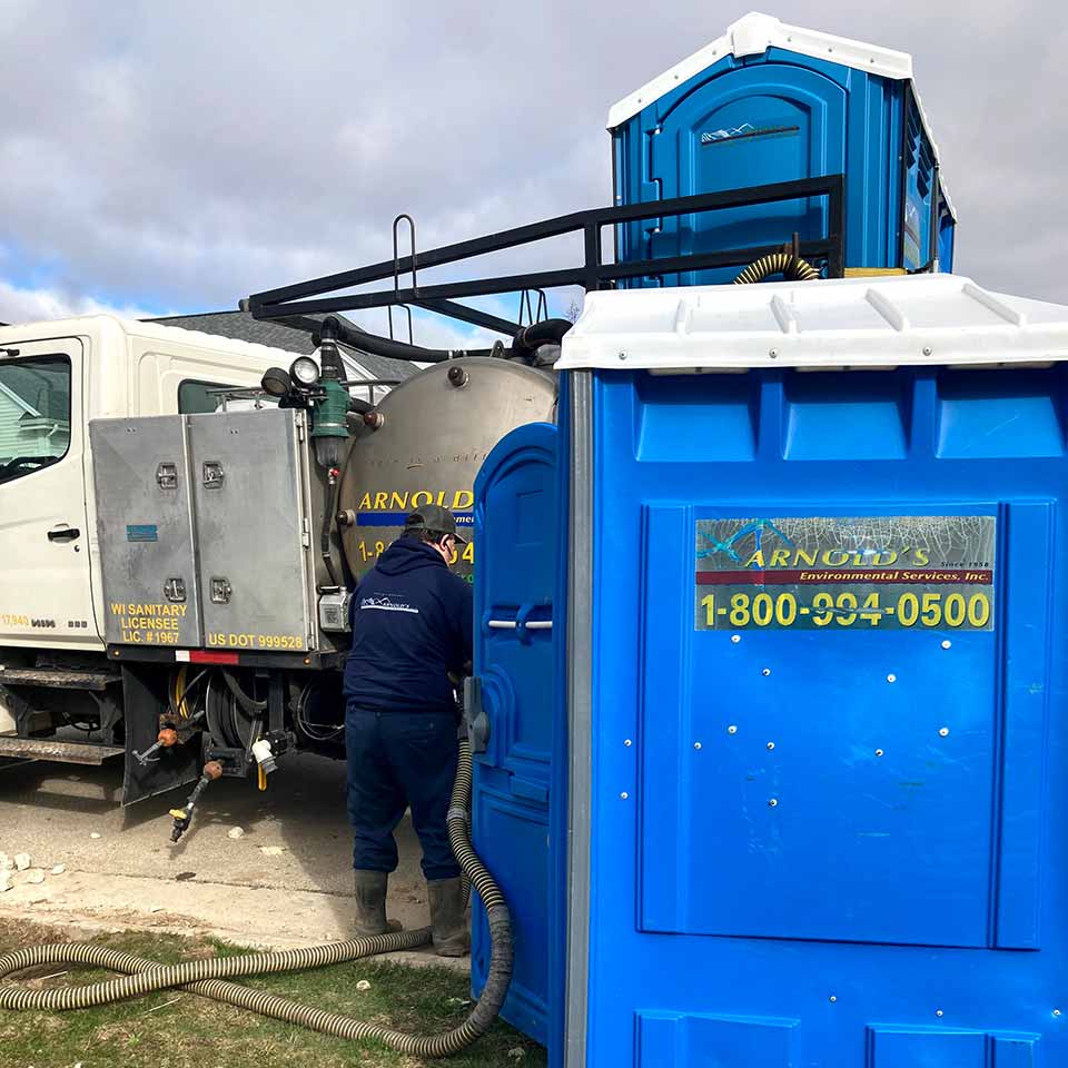 AES Team Maintaining a Basic Portable Restroom. AES Team Maintaining a Basic Portable Restroom.